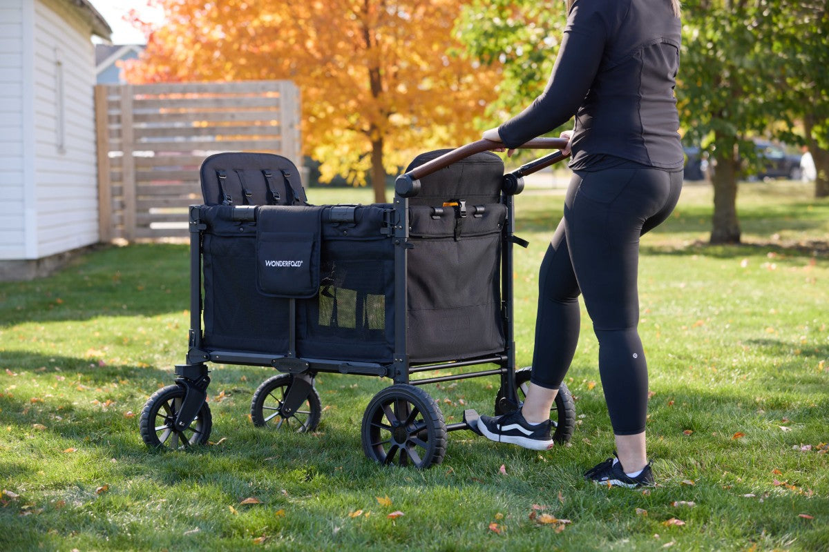 Mom easily uses adjustable handle bar and sandal-friendly brakes on a W4 Luxe Pro