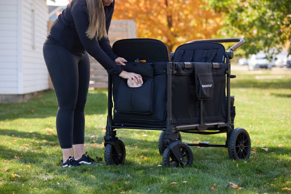 mom utilizes deep carriage design for storage on W4 Luxe Pro Stroller Wagon