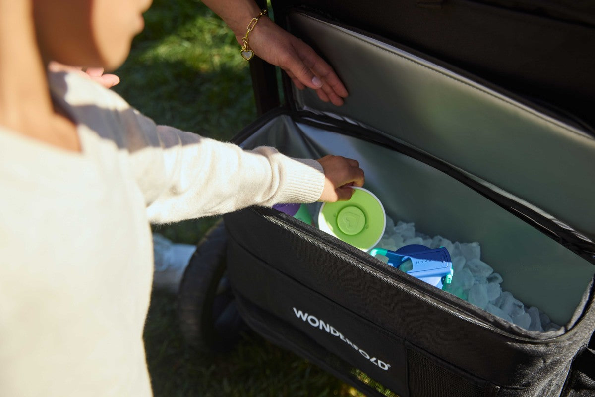 Parents puts items in W4 Luxe Pro's Insulated Rear Storage Basket with ample storage