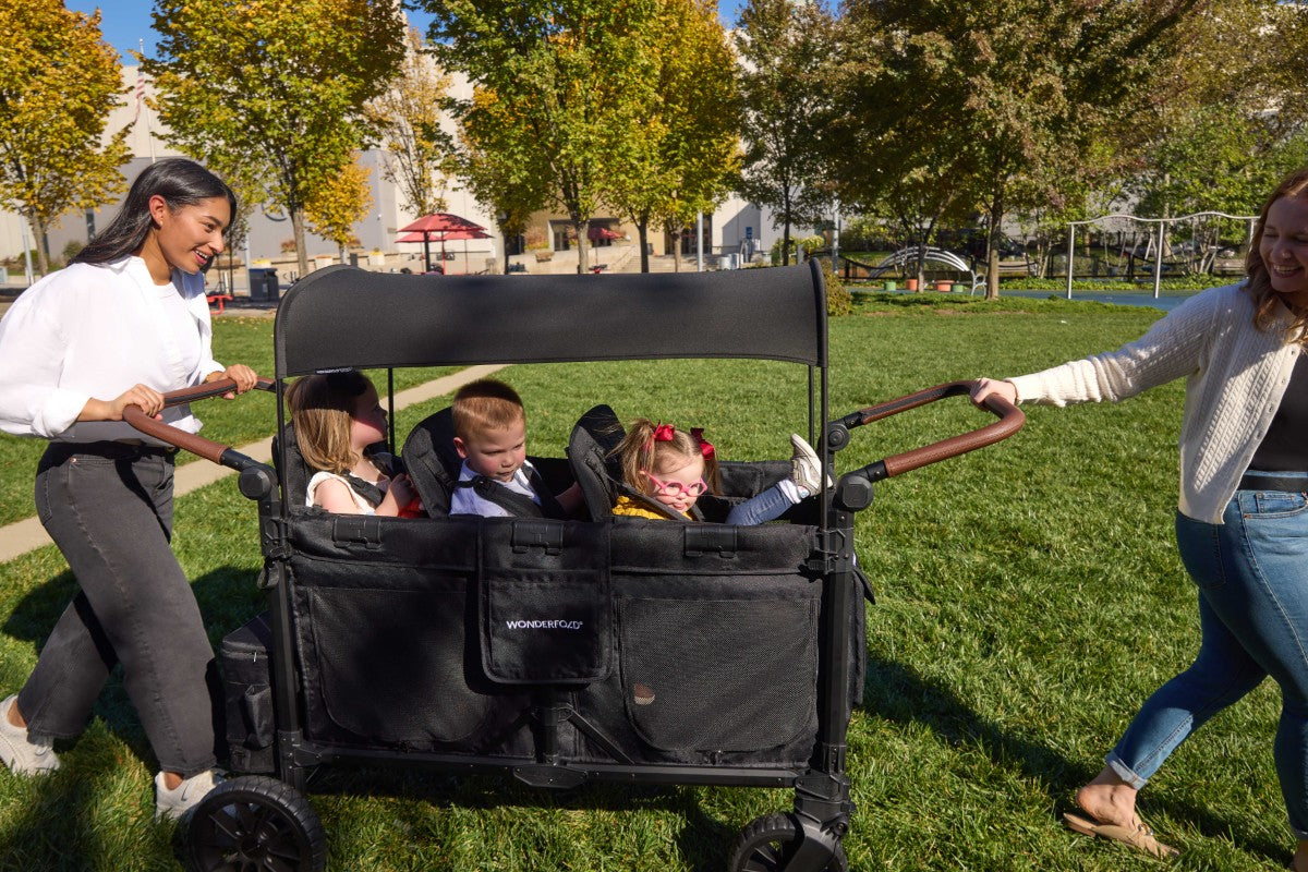 three babies are enjoying an outing in W6 Luxe Pro Stroller Wagon's three benches